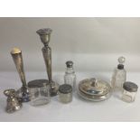 A group of Victorian and later silver lidded and mounted cut glass dressing table bottles and