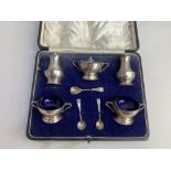A cased George V silver five piece cruet set, maker Josiah Williams & Co, London 1928, with blue