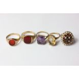 A garnet and seed pearl dress ring; an amethyst ring; a citrine ring; two hardstone set signet