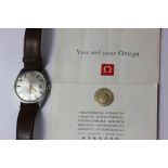 A steel Omega wrist watch, Geneve range, automatic with date and paperwork c1970