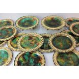 A Wedgwood majolica part dessert service, with pierced Greek key pattern borders enclosing green,