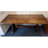 A 20th century oak refectory dining table, on shaped supports joined by a central stretcher, 183cm