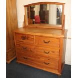 A modern pine bow front dressing chest, with adjustable mirror back above four short over four