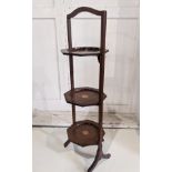 An Edwardian inlaid mahogany three tier folding cake stand, on outswept supports, 86cm high
