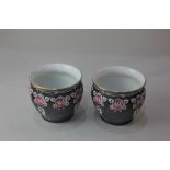 A pair of Shelley porcelain jardineres, decorated with pink roses on black ground, 10.5cm high