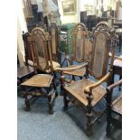 A set of three Baronial style high back dining chairs, to include one carver, with cane back and