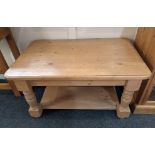 A pine coffee table, rectangular top with rounded corners, with under shelf, on turned legs and