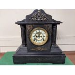 An Ansonia New York black slate mantle clock of architectural form, the circular enamel dial with