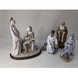 A large Lladro porcelain figure group of a medieval couple beside a tomb with two doves, 34.5cm