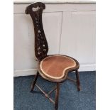 An early 20th century Spinners chair with pierced scroll back, heart shaped padded seat on turned