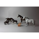 A Beswick model of a standing horse in dappled grey, 20cm high, and another in brown gloss, 20cm