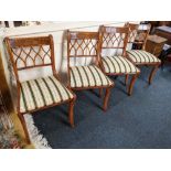 A set of four yew wood dining chairs, with upholstered drop-in seats on sabre front legs