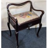 A 20th century mahogany piano stool, with curved rail back, the hinged tapestry seat above shell