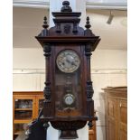 A Victorian walnut Vienna style wall clock, in glazed case with carved mask head surmount, 85cm,
