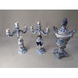 A pair of Augustus Rex style blue and white porcelain three branch candelabra, modelled with