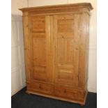 A modern pine wardrobe (converted to a cupboard), with two panel doors enclosing three removable