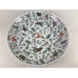 A Chinese Cantonese porcelain charger, decorated with various butterflies and flowers all over,