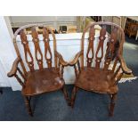 A pair of Windsor style carver dining chairs, with pierced spat backs and curved arms on turned