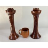 A pair of 1960s Ben Owen studio pottery candlesticks, with brown glaze, maker's stamp to base, 30.