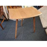 An Ercol pale wood table extender, with rounded top on three splayed legs, 69cm