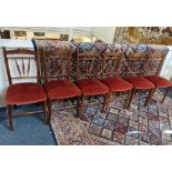 A set of six early 20th century stained beech spindle back dining chairs, with red upholstered seats