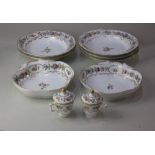 A 19th century porcelain part dessert service, decorated with pink roses and other flowers on