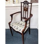 An Arts and Crafts mahogany framed armchair, the back with carved tree and abalone inlaid stylized