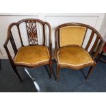 Two Edwardian tub chairs with matching upholstery, one with vertical pierced back splats and