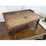 A rectangular tray top bed table carved with initials GFH, with rippled fluted edge, raised on