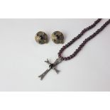 An amethyst bead necklace hung with a silver cross, a pair of cabochon ear clips