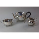 A late Victorian silver three piece tea set including tea pot, sugar bowl and cream jug of oval form