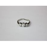 A diamond three stone ring claw set with graduated round stones in 18ct white gold