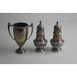 A pair of Victorian silver pepper pots with reeded bases, London 1894 and a small George V silver