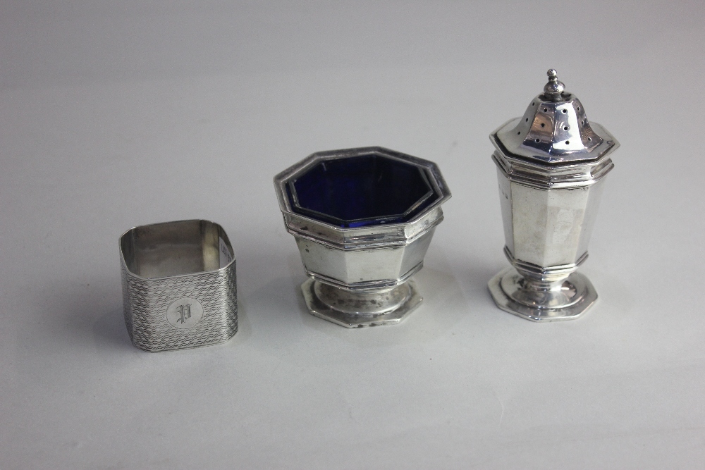 A George V matching silver salt cruet and pepper pot octagonal pedestal form maker ES Barnsley,