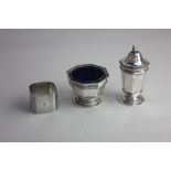 A George V matching silver salt cruet and pepper pot octagonal pedestal form maker ES Barnsley,