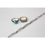 A silver bracelet with Greek key pierced links, a blue stone ring indistinctly marked, and a BFL
