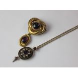 A Victorian amethyst and seed pearl oval drop pendant on yellow metal mount and chain and yellow
