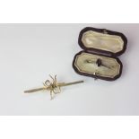 A gem set insect bar brooch in case; an oval bar brooch in case