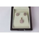 A pair of diamond cluster ear studs; pave set, on plain post and butterfly fittings; and a