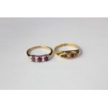 An 18ct gold ruby and diamond dress ring with three oval rubies and four alternate pairs of small
