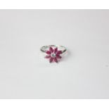 A 9ct white gold ruby and sapphire flower shaped ring