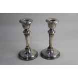 A pair of Edward VII silver candlesticks baluster shape on loaded circular bases, maker S