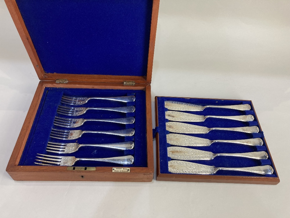 A set of six pairs of silver plated fish knives and forks with engraved blades in fitted case by