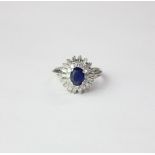 A sapphire and diamond 'ballerina' dress ring the central stone in a pave set diamond bezel and