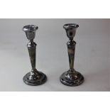 A pair of modern silver dwarf candlesticks on loaded circular bases, Birmingham 1974 and another