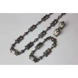 A mid 20th century Georg Jensen silver necklace and matching bracelet scroll and berry design