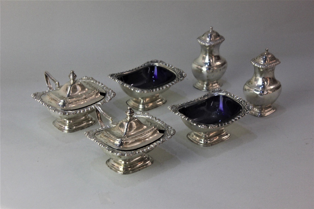 A matched six-piece George V silver cruet set of a pair of mustard pots, salt cruets and pepper pots