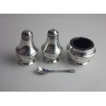 A modern silver three piece cruet set of circular mustard pot with blue glass liner and spoon,