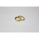 A 22ct gold wedding band and a gilt metal ring