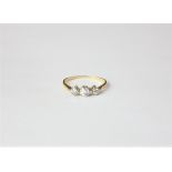 A diamond three stone ring the graduated old cuts rubover set in yellow gold